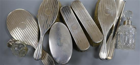 A five piece silver mounted mirror and brush set, one other brush, two toilet jars, button hook and shoe horn.